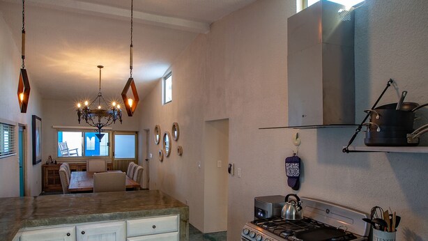 A spacious kitchen with a central island, a stove, and a ceiling fan. - Great Rental for Families and Small Groups in Downtown Cabo San Lucas (Cabo San Lucas)