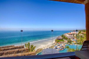 A resort view with a beach, pool, and ocean.