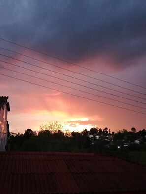 Ein Sonnenuntergang über einer Wohngegend mit Häusern und Stromleitungen.