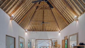 A spacious room with a high ceiling, wooden furniture, and a large bed with a view. - Charming Tropical Villa for Couple and Honeymooner (Gianyar)