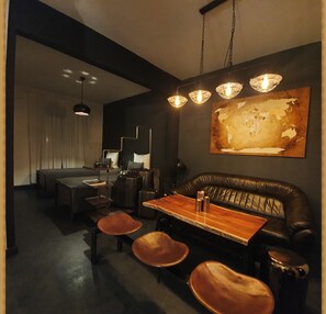 Relax in a stylish seating area with a leather couch and chairs, surrounded by modern art and clean lines.