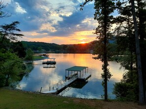 A lakeside view with a dock and a covered area. - LAKEFRONT 4/3.5, Private Dock, Pool Table, Lakeside Firepit, Kayaks, Paddleboat (Young Harris)