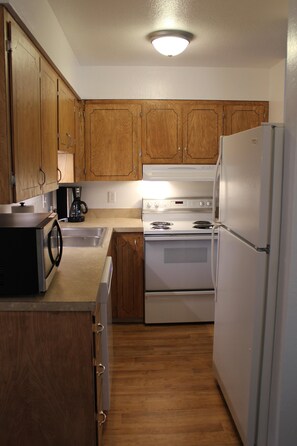 Fridge, microwave, coffee/tea maker, cookware/dishes/utensils