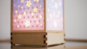 A wooden lantern with a geometric pattern.
