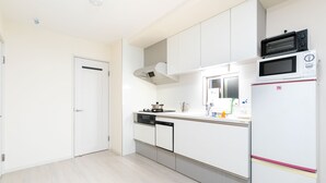 A modern kitchen with white cabinets, a microwave, a dishwasher, and a stove. - All New Beautiful Villa.NearU.S.JNanba (Ōsaka-shi)