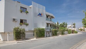 A modern building with a flat facade, a prominent logo, and a gated entrance. - Enjoy a Holiday of a Lifetime Renting Your Own Apartment in Ayia Napa at the Best Rate (Ayia Napa)