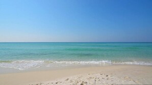 A beach with clear turquoise water and a sandy shore. - Island Princess 416 * Gulf front~Beach Chair Set Included * Salt Water Vacations (Fort Walton Beach)