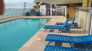 This condo is a total getaway!  Relax by the pool with direct views of the bay