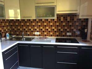 Refrigerador, microondas, utensilios de cocina, mesa de comedor