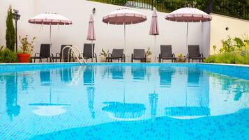 Seasonal outdoor pool, open 8:00 AM to 8:00 PM, pool umbrellas