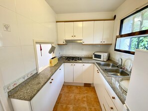 Fridge, coffee/tea maker, toaster, cookware/dishes/utensils