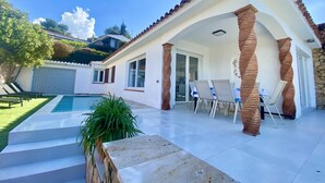 A house with a swimming pool, outdoor seating, and a covered patio area. - Villenpark Playa Arena House Ocean (Lloret de Mar)
