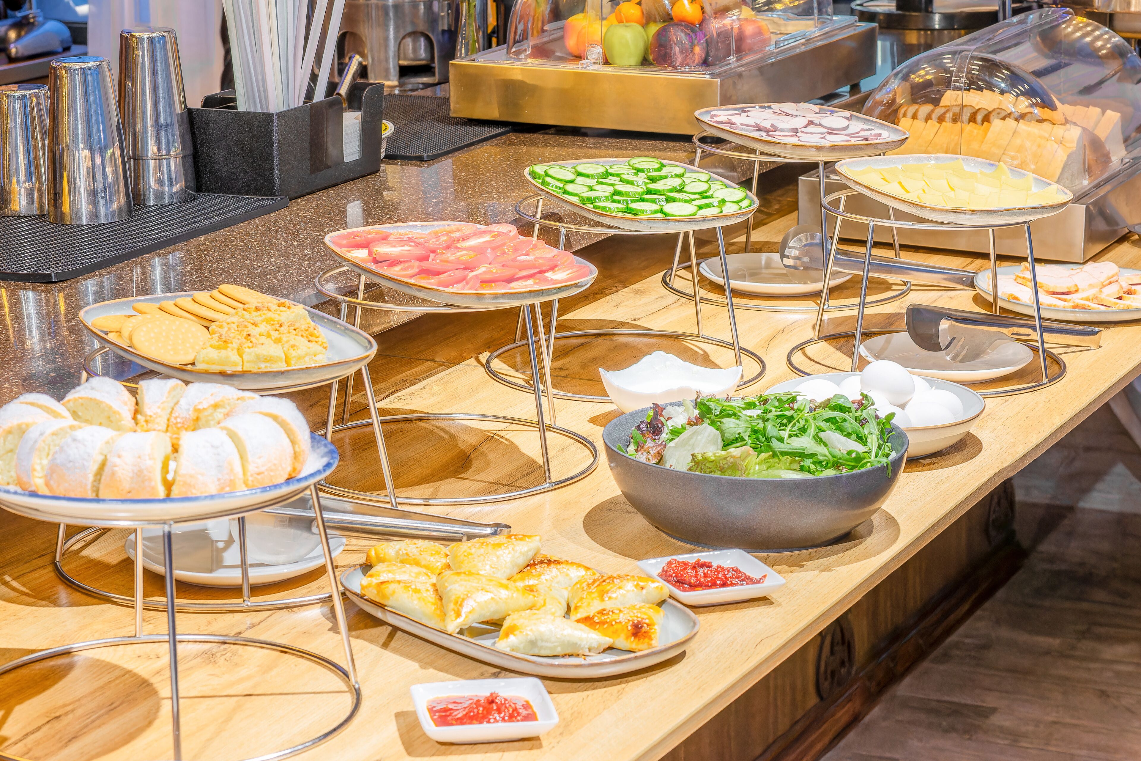 A buffet with various food items including pastries, salads, and meats.