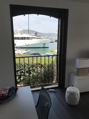 Enjoy a marina view from the comfort of this room, featuring a desk, chair, and ottoman.