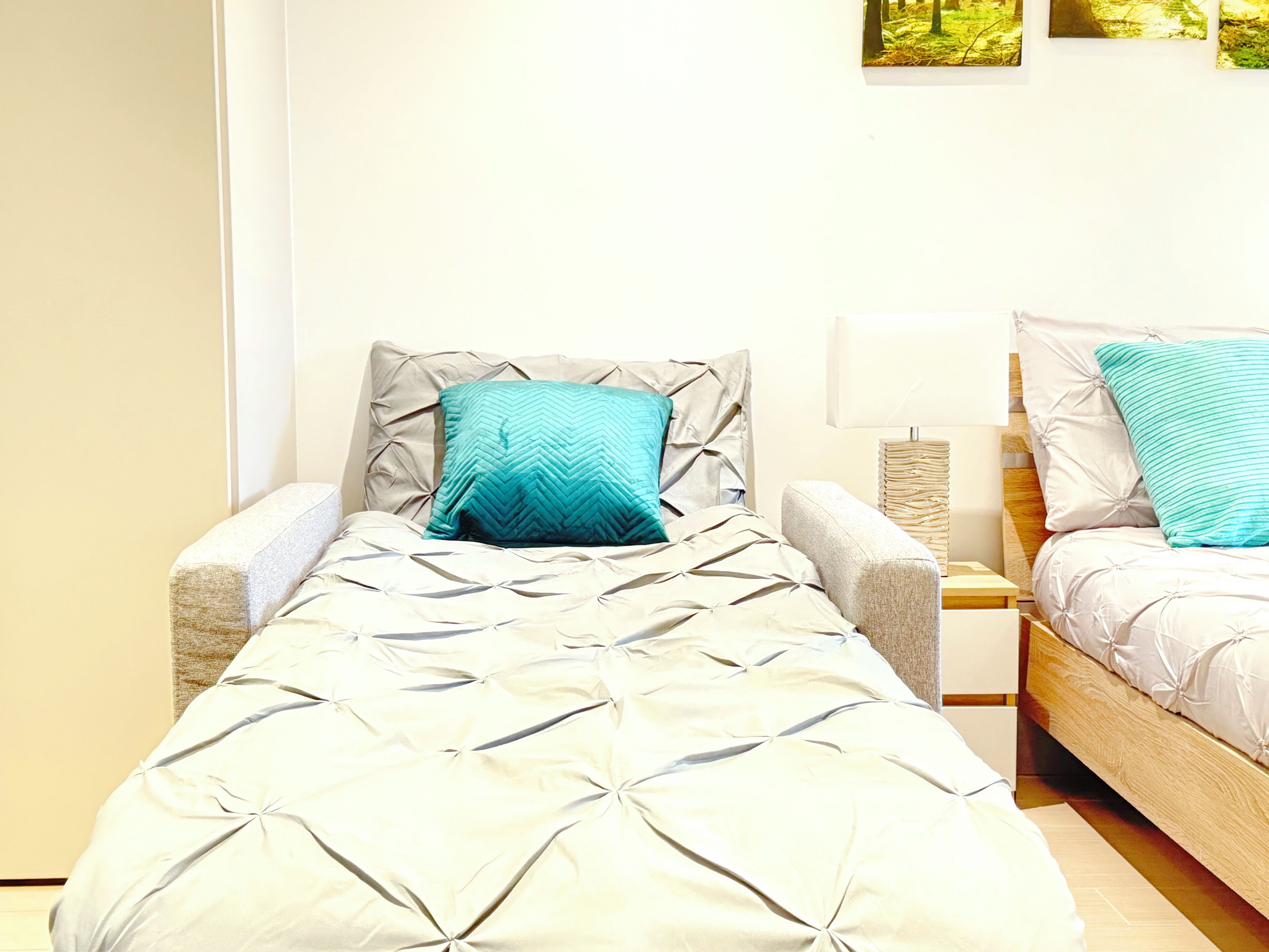 A twin room with two single beds, each with a headboard and a bedside table.