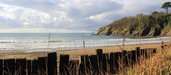 Turreted gatehouse to the historic Caerhays Castle located on the beach on the south Cornish Coast