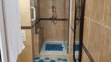 Shower, hair dryer, towels, toilet paper