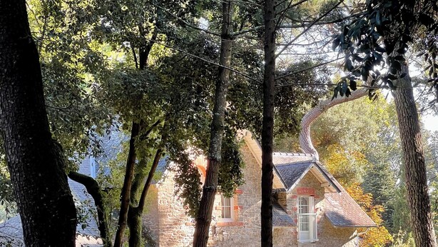 A stone house with a red roof, surrounded by trees and greenery. -  Typical charming residence in 400 of the beach in park sported of 4000m2 (Pornichet)