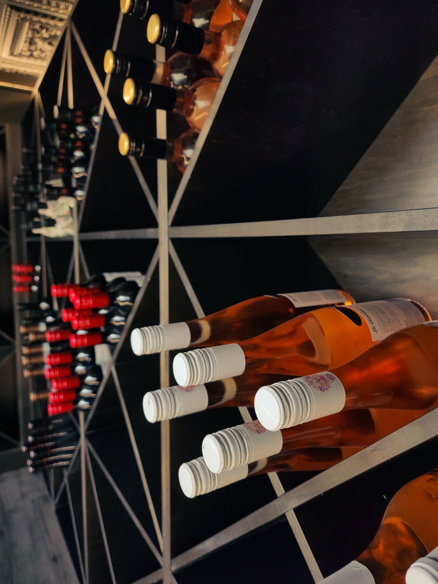 A wine rack with bottles arranged in rows.