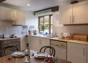 Enjoy cooking in this well-equipped kitchen with a central island, sink, and ample counter space.