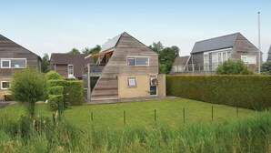 A modern residential area with houses featuring sloped roofs and wooden facades.