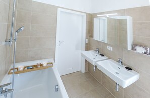 Bathtub, hair dryer, slippers, towels