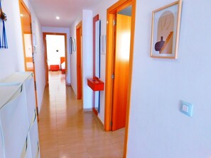 Stylish corridor with artwork and a convenient storage unit.