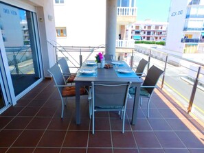 Enjoy dining al fresco on this balcony with a table set for four.
