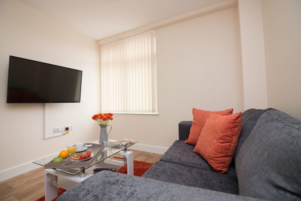 Apartamento, varias camas (Apartment 6) | Zona de estar | Una televisión de pantalla plana