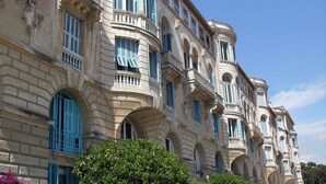 A historic building with classical architecture, featuring arched windows and balconies. - LOVELY DUPLEX IN A PALACE (Beausoleil)