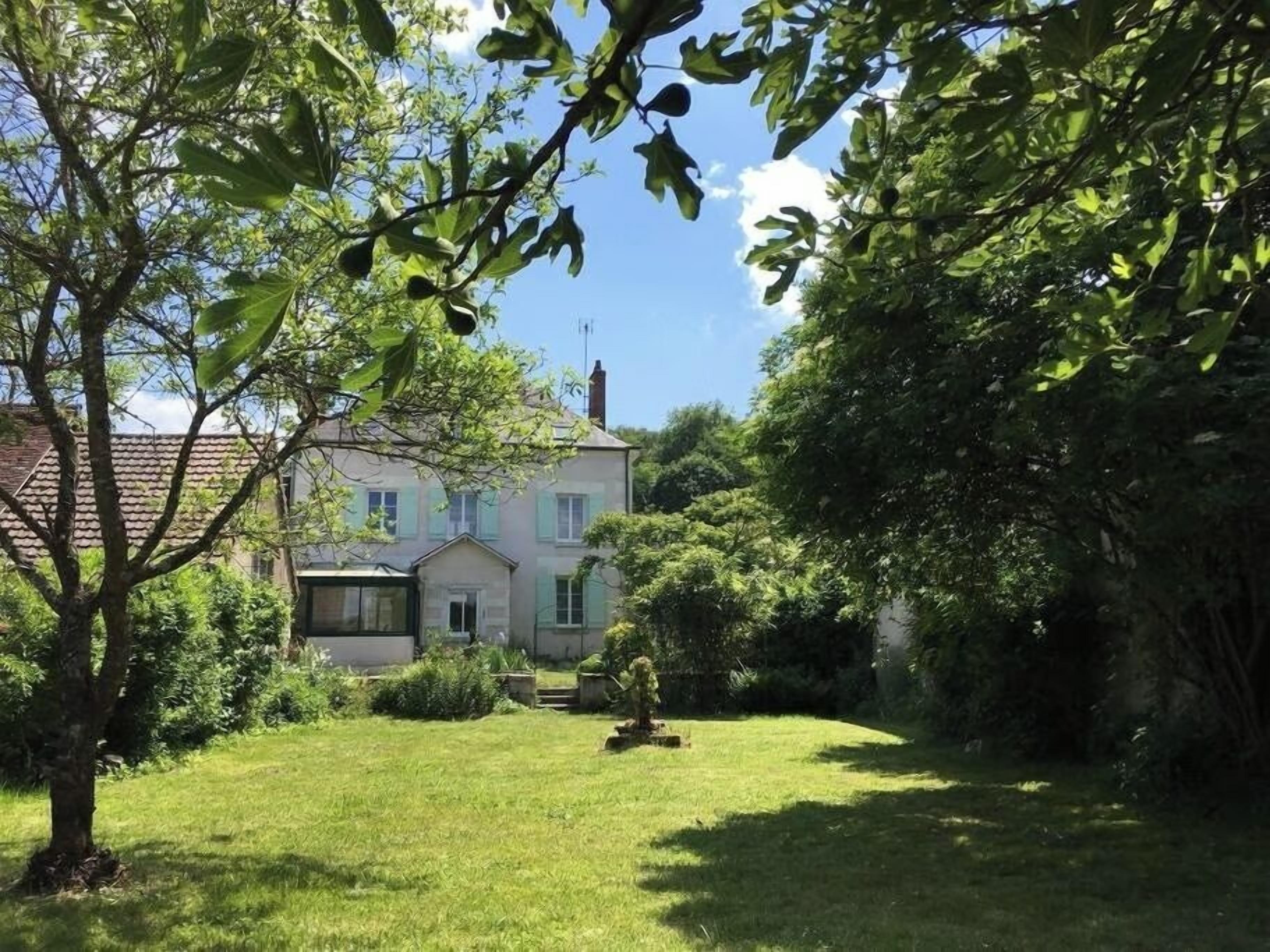 A house with a well-maintained lawn and a small garden area.