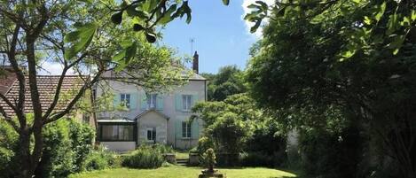 A house with a well-maintained lawn and a small garden area.