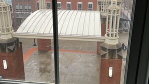 A view through a window of a building with a flat roof and brick chimneys. - "Market View" 2Br, 2ba, Best view of the Market Square, Great Location (Knoxville)