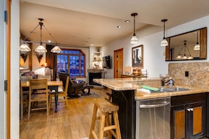 Enjoy meal preparation and dining in this well-appointed kitchen with a central island, sink, and dishwasher.