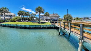 A waterfront property with a wooden dock, a pool, and a gazebo. - Pop's Place in the private gated community of Inlet Harbour (Garden City Beach)