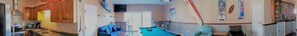 A compact living area with a pool table, a sofa, and a dining table. - In the HEART of Ocean Drive in North Myrtle Beach (North Myrtle Beach)