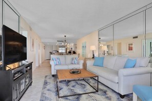 Relax in this stylish living room with a flat-screen TV, comfortable sofa, and a functional layout.