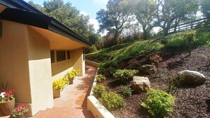 Stroll through the beautifully landscaped garden to the entrance of this serene retreat.