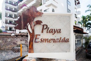 A sign for Playa Esmeralda with a tree silhouette. - Ocean Front/Heated Pool, 6 Adults+ 2 kids under 12 (Puerto Vallarta)