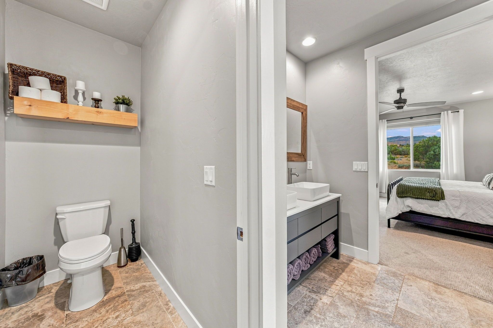 A bathroom with a toilet, sink, and shower area.