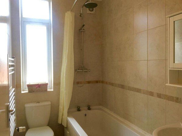 A bathroom with a bathtub, a shower, and a toilet.