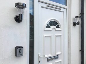 A white door with a glass panel and a small window above it.