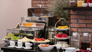 A buffet setup with various food items and beverages, including salads, fruits, and dairy products. - Marina Hotel (Hanoi)