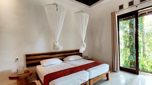 A double bed with a wooden headboard, a bedside table, and a window with a view of greenery. - Villa Sari Lombok, Hidden treasure (Lombok)