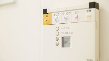 A control panel with Japanese text and symbols, likely for a bathroom or similar facility.