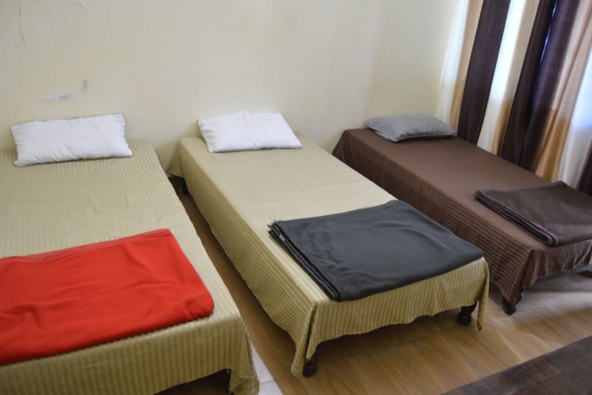 Economy Shared Dormitory, 3 Single Beds, Mountain View | Living room | 28-inch LED TV with cable channels, TV