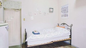 A small, tidy room with a single bed, a desk, and a door. - Home WIFI & Compact & Tranquil Apt with LOFT! (Tokyo)