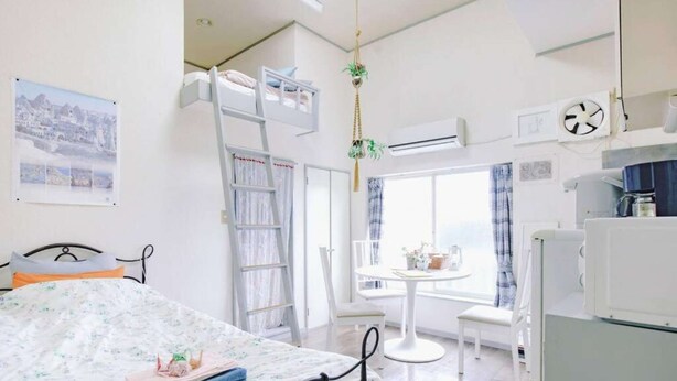 A bedroom with a bed, a desk, a chair, a ladder, and a window. - Home WIFI & Compact & Tranquil Apt with LOFT! (Tokyo)