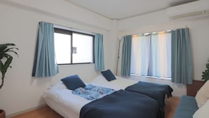 A room with two beds, a large window with curtains, a potted plant, and a ceiling light. - V.Close to Shinjuku Kabukicho/Korean Town/FrWIFI A (Shinjuku)