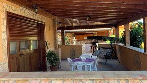 An outdoor patio with stone walls, a wooden ceiling, and a stone fireplace. - Apartment/ flat - SICULIANA House with garden (SICULIANA)